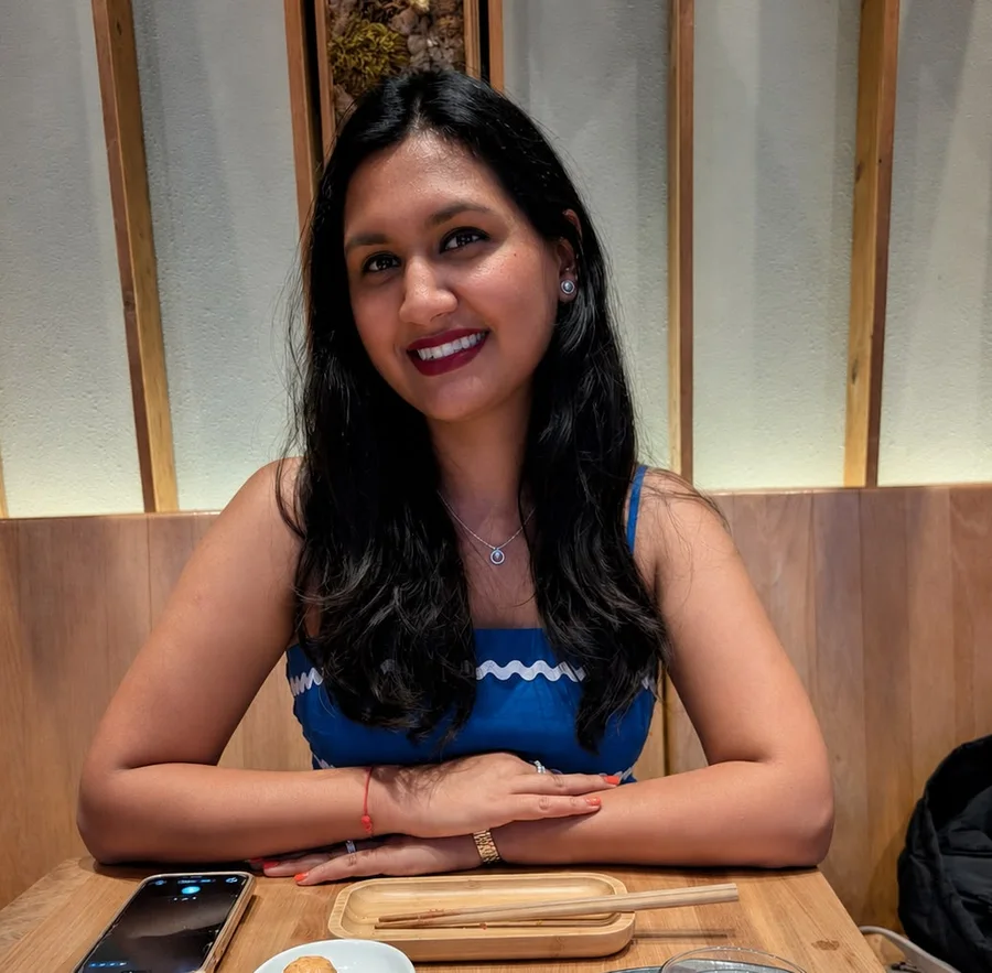 Anuri Shah, smiling at a restaurant table